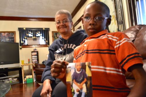 tephen Gibson, 9, sits with his mother at their home in Cleveland on Monday, Nov. 11, 2013.