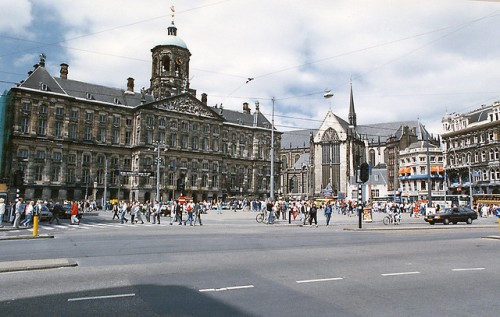 Turis lokal dan asing menyempatkan diri membaur di kawasan Dam Square menikmati cuaca cerah saat musim panas di Amsterdam.